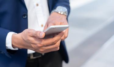 A business person using a smartphone...
